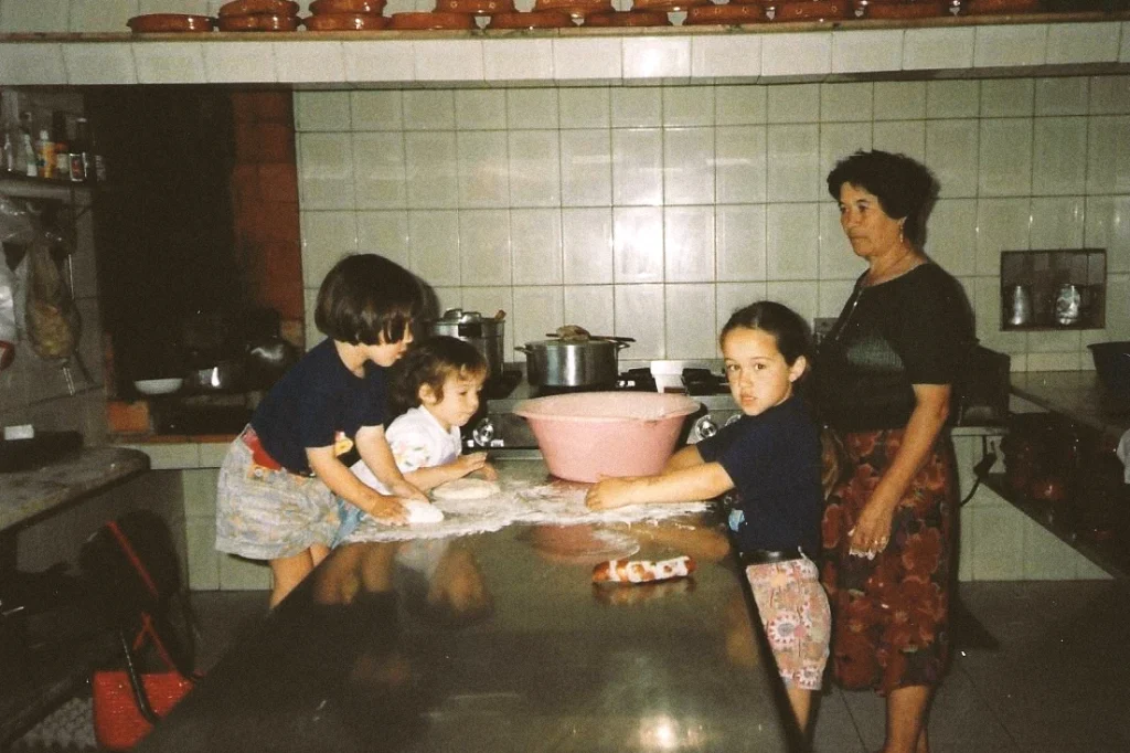 Children baking with grandma in kitchen