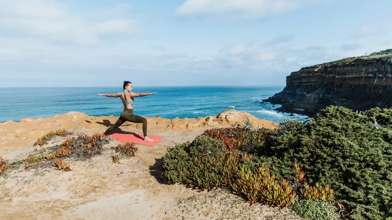 Yoga teacher practicing on the cliffs