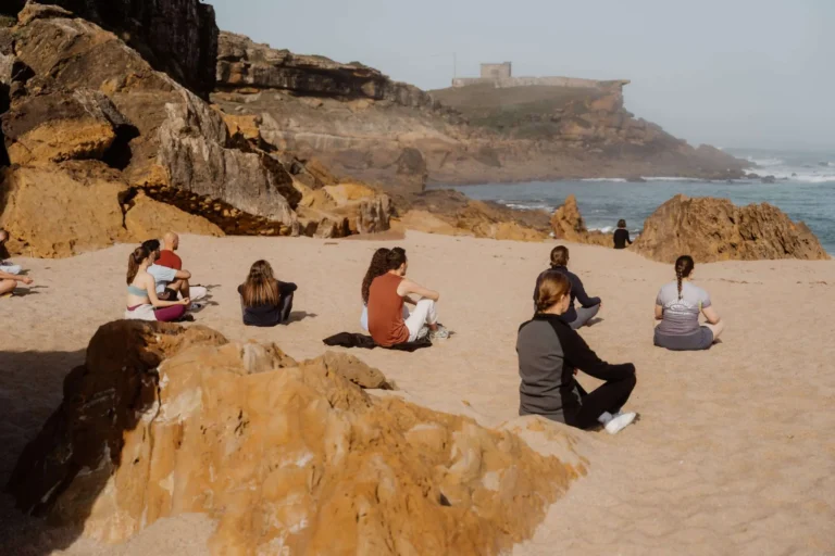 People meditating at the beach in Ericeira